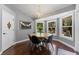 Dining area with a round wood table, four chairs, and large windows offering natural light at 12503 Bronco Dr, Tampa, FL 33626