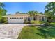 Charming single-story home with a manicured lawn and a driveway made of decorative pavers at 12503 Bronco Dr, Tampa, FL 33626