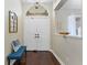 Bright foyer featuring a double door entry, hardwood floors, and elegant decorations at 12503 Bronco Dr, Tampa, FL 33626