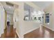 Hallway with wood floors leading to the kitchen area and a bedroom with a sliding door at 12503 Bronco Dr, Tampa, FL 33626