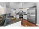 Modern kitchen with stainless steel appliances, white cabinets, and dark countertops at 12503 Bronco Dr, Tampa, FL 33626