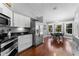 Kitchen with stainless steel appliances, white cabinets, and an eat-in dining area with bay windows at 12503 Bronco Dr, Tampa, FL 33626