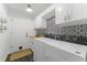Well-lit laundry room featuring a modern washer and dryer at 12503 Bronco Dr, Tampa, FL 33626