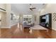 Spacious living room features a ceiling fan, hardwood floors, and access to the screened-in lanai at 12503 Bronco Dr, Tampa, FL 33626