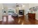 Spacious living room with wood floors, high ceilings, and sliding glass doors to the pool area at 12503 Bronco Dr, Tampa, FL 33626
