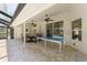 A screened-in lanai with a ping pong table next to the pool, and outdoor dining at 12503 Bronco Dr, Tampa, FL 33626