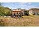 Backyard featuring a brick patio, gazebo, seating, and well-maintained lawn for outdoor enjoyment at 13312 Waterford Castle Dr, Dade City, FL 33525