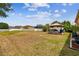 Large backyard with a gazebo and seating area, bordered by a white fence at 13312 Waterford Castle Dr, Dade City, FL 33525