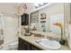Bathroom with dark wood vanity, granite countertop, decorative mirror, and shower-tub combo at 13312 Waterford Castle Dr, Dade City, FL 33525