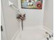 White bathtub with chrome fixtures and decorative painting on the wall above at 13312 Waterford Castle Dr, Dade City, FL 33525