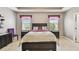 Bedroom with large bed, bedside tables and neutral colors at 13312 Waterford Castle Dr, Dade City, FL 33525
