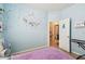 Bedroom featuring blue walls, wood flooring, a work area, and whimsical decor at 13312 Waterford Castle Dr, Dade City, FL 33525