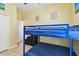 Bedroom with a blue bunk bed and natural light at 13312 Waterford Castle Dr, Dade City, FL 33525