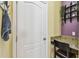 Hallway desk with granite countertop, white door, and decor at 13312 Waterford Castle Dr, Dade City, FL 33525