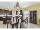 Well-lit open floor plan features kitchen with stainless appliances, dark cabinets, and dining area at 13312 Waterford Castle Dr, Dade City, FL 33525