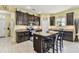 Modern kitchen featuring granite countertops, dark cabinetry, and a center island at 13312 Waterford Castle Dr, Dade City, FL 33525