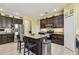 Spacious kitchen with stainless steel appliances, an island with seating, and ample storage at 13312 Waterford Castle Dr, Dade City, FL 33525