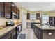 Modern kitchen with granite counters, stainless appliances, and dark wood cabinets at 13312 Waterford Castle Dr, Dade City, FL 33525