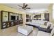 Spacious living room features a sectional couch, entertainment center, and an open layout at 13312 Waterford Castle Dr, Dade City, FL 33525