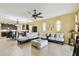 Comfortable living room area with a large sectional couch and open access to the kitchen at 13312 Waterford Castle Dr, Dade City, FL 33525