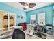 Well-lit home office featuring a comfortable sofa, desk, and ample storage at 13312 Waterford Castle Dr, Dade City, FL 33525