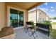 Covered patio space with a view of the backyard and wooden chairs, planter boxes at 13312 Waterford Castle Dr, Dade City, FL 33525