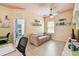 room features a ceiling fan, sofa, TV and adjacent work room at 13312 Waterford Castle Dr, Dade City, FL 33525