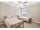 Spare bedroom with two twin beds, neutral walls, ceiling fan, and lots of light at 13419 Willow Bluestar Loop, Riverview, FL 33579
