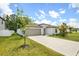 Well-maintained single-Gathering home with a two-car garage and landscaped front yard at 13419 Willow Bluestar Loop, Riverview, FL 33579
