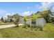 Inviting home with a two-car garage, complemented by a green lawn and sunny skies at 13419 Willow Bluestar Loop, Riverview, FL 33579