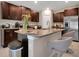 Modern kitchen with granite countertops, stainless steel appliances, and stylish breakfast bar seating at 13419 Willow Bluestar Loop, Riverview, FL 33579