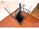 Unique spiral staircase leading to an upper level, encased in a square stairwell with a tile floor at 13931 Hatcher Ave, Hudson, FL 34667