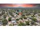 Overhead view captures a cozy single-story home, nestled among tree-lined streets and near a scenic lake at 1416 Murray Ave, Clearwater, FL 33755