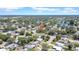 An aerial view showcases this home's location within a mature, tree-lined community near a serene pond at 1416 Murray Ave, Clearwater, FL 33755