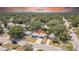 Aerial view of a charming home nestled among lush trees in a quiet neighborhood with city views at 1416 Murray Ave, Clearwater, FL 33755