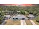 Aerial view of a single-story home with a fenced yard, mature trees, and a well-maintained lawn at 1416 Murray Ave, Clearwater, FL 33755