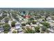 Overhead view captures a cozy single-story home, nestled among tree-lined streets and near a scenic lake at 1416 Murray Ave, Clearwater, FL 33755