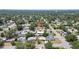 A serene aerial view captures a single-story home among lush green trees, showcasing a tranquil neighborhood setting at 1416 Murray Ave, Clearwater, FL 33755