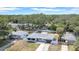 Aerial view of a single-story home with a fenced yard, mature trees, and a well-maintained lawn at 1416 Murray Ave, Clearwater, FL 33755