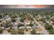 Serene neighborhood home with mature trees, long driveway, and easy access to nearby lake and city at 1416 Murray Ave, Clearwater, FL 33755