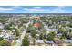 Expansive aerial view of a neighborhood with mature trees, showcasing the community and surrounding area under a bright sky at 1416 Murray Ave, Clearwater, FL 33755