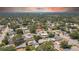 Quiet residential neighborhood, home with a long driveway and mature trees near a distant city at 1416 Murray Ave, Clearwater, FL 33755