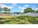 Spacious backyard with lush green grass and a white fence, perfect for outdoor activities at 1416 Murray Ave, Clearwater, FL 33755