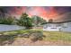 Backyard featuring a privacy fence and lush greenery under a colorful sunset sky at 1416 Murray Ave, Clearwater, FL 33755