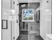 Modern bathroom featuring a glass enclosed shower and black-and-white honeycomb tile at 1416 Murray Ave, Clearwater, FL 33755