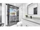 Modern bathroom with glass enclosed shower, black hardware, and a stylish vanity with a white countertop at 1416 Murray Ave, Clearwater, FL 33755