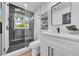 A modern bathroom featuring a glass shower, black hardware and modern fixtures at 1416 Murray Ave, Clearwater, FL 33755