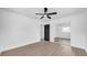 Clean, modern bedroom with hardwood floors, a ceiling fan, and closet with mirror doors at 1416 Murray Ave, Clearwater, FL 33755
