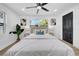 The main bedroom features two large windows, neutral paint, and modern lighting at 1416 Murray Ave, Clearwater, FL 33755