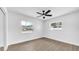 Bright, neutral bedroom featuring hardwood floors, a ceiling fan, and large windows offering natural light at 1416 Murray Ave, Clearwater, FL 33755